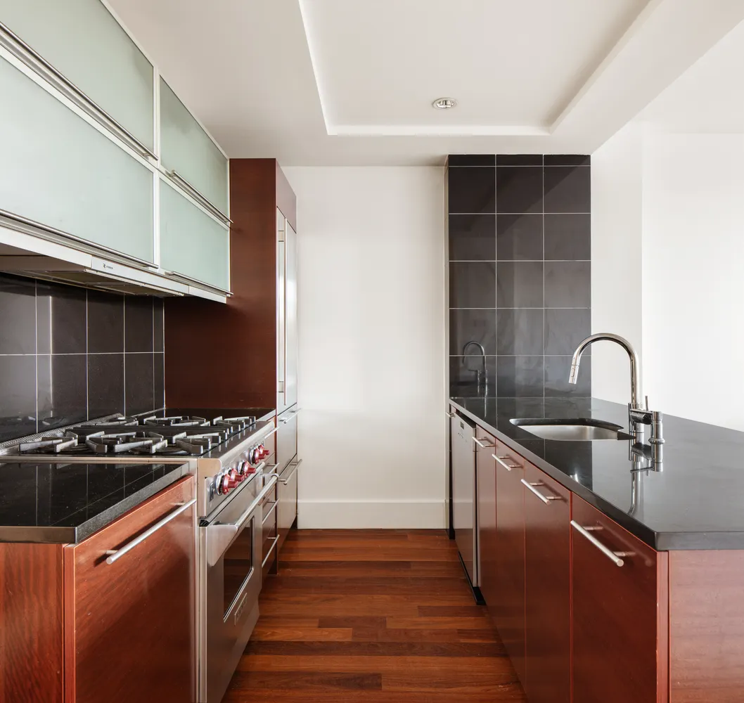 a kitchen with granite countertop a stove and a sink