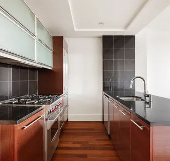 a kitchen with granite countertop a stove and a sink