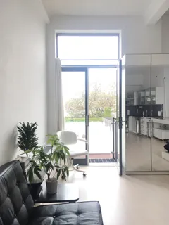 a dining room with furniture and a potted plant