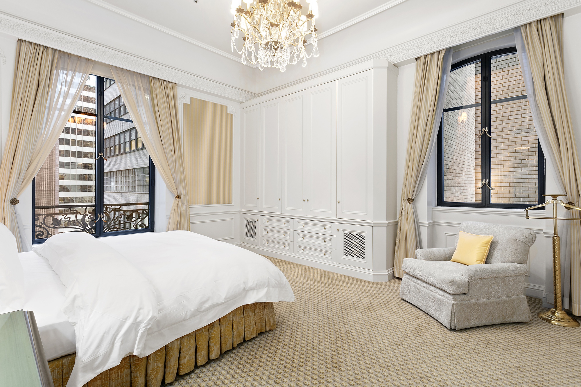 2 East 55th Street, Unit 1116 Manhattan, NY 10022 - Photo 2 of 14 a spacious bedroom with a large bed and a couch