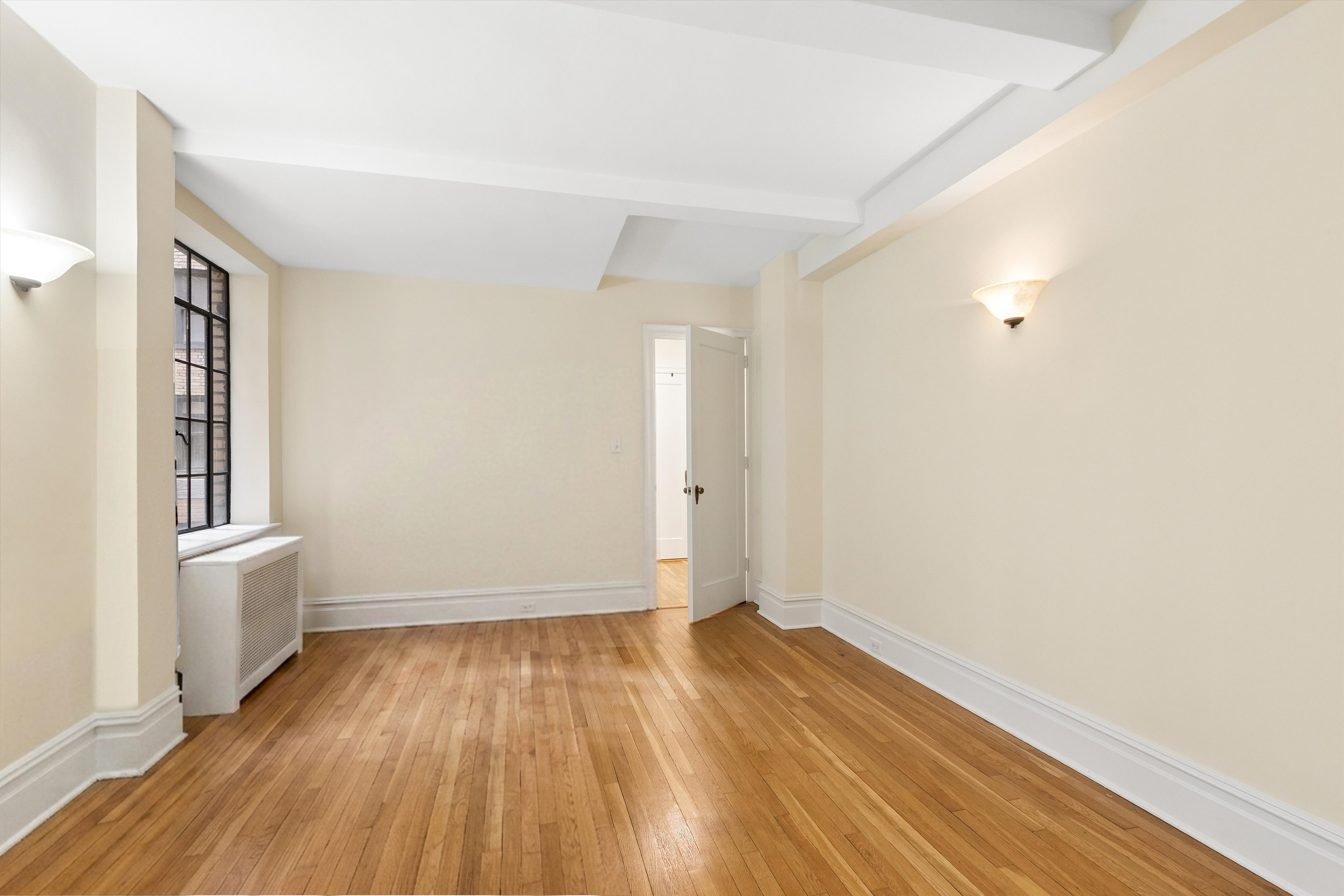 444 East 52nd Street, Unit 3C Manhattan, NY 10022 - Photo 11 of 19 a view of empty room with wooden floor and fan