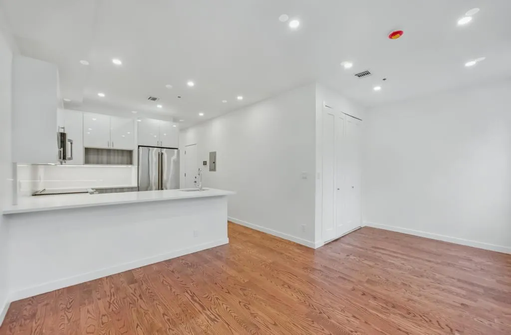 a view of kitchen with stainless steel appliances cabinets and wooden floor