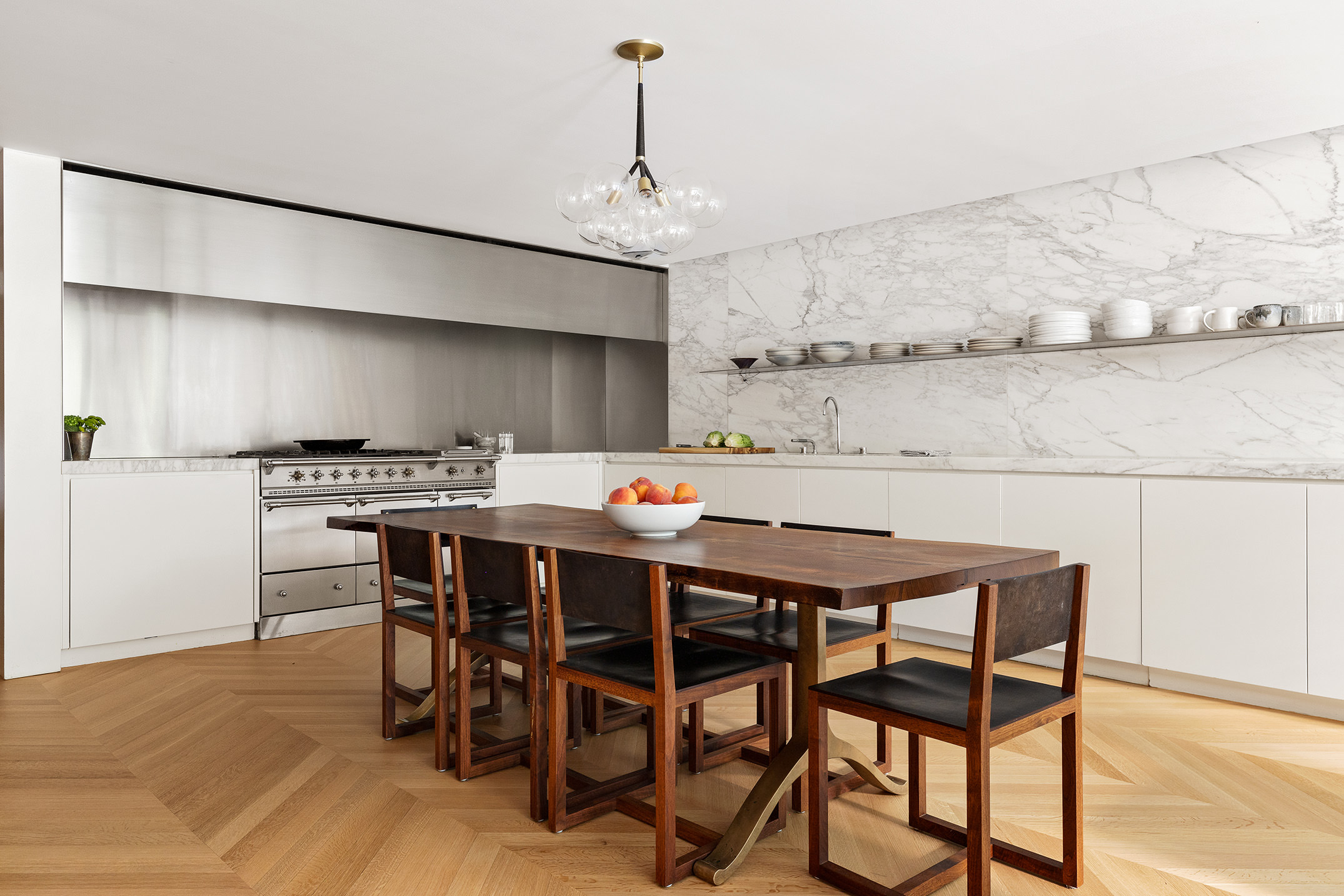 55 West 9th Street Manhattan, NY 10011 - Photo 14 of 20 a kitchen with a dining table and chairs