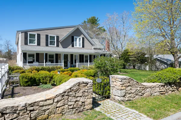 a front view of a house with garden
