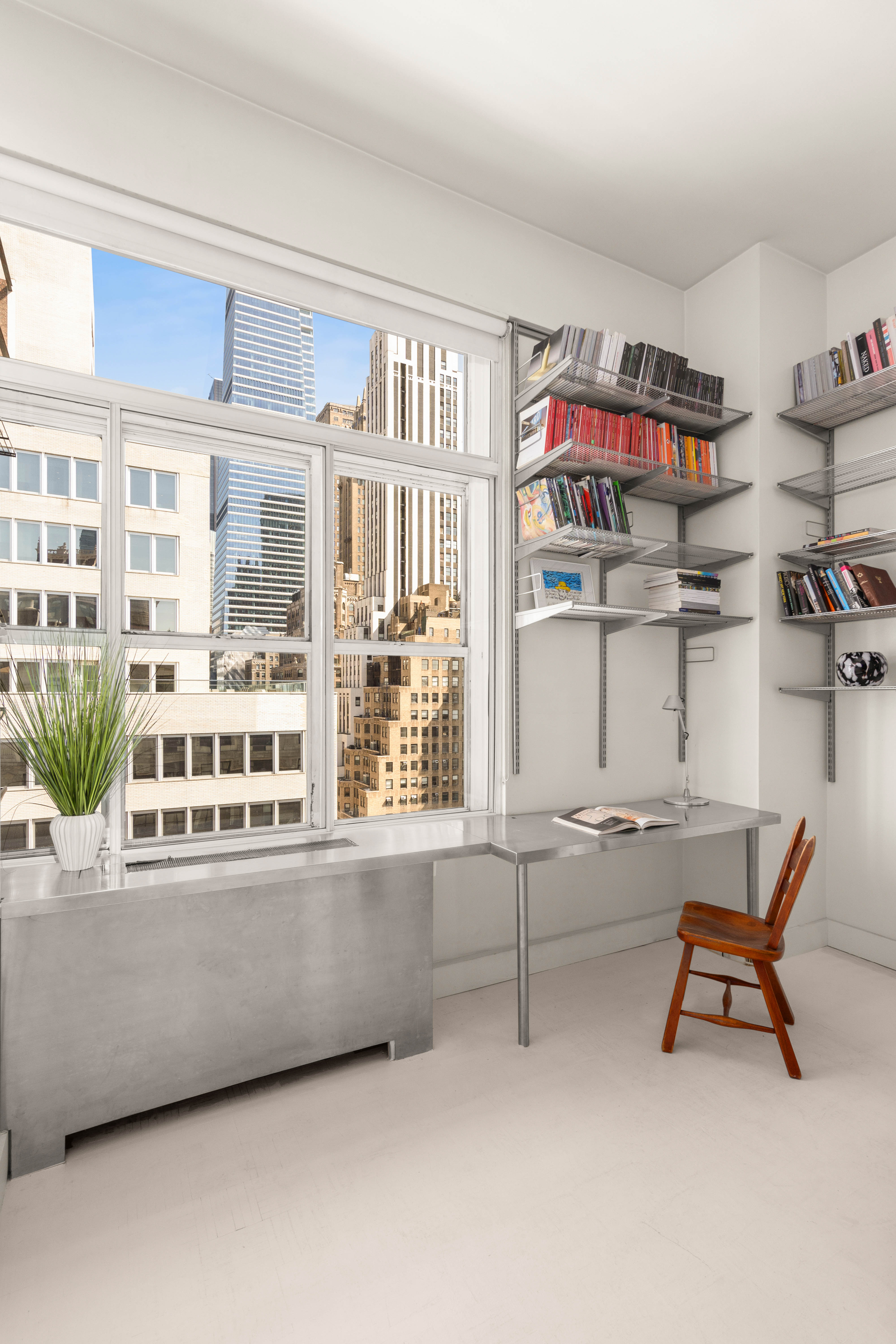 244 Madison Avenue, Unit PHE Manhattan, NY 10016 - Photo 5 of 20 a living room with furniture cabinets and window