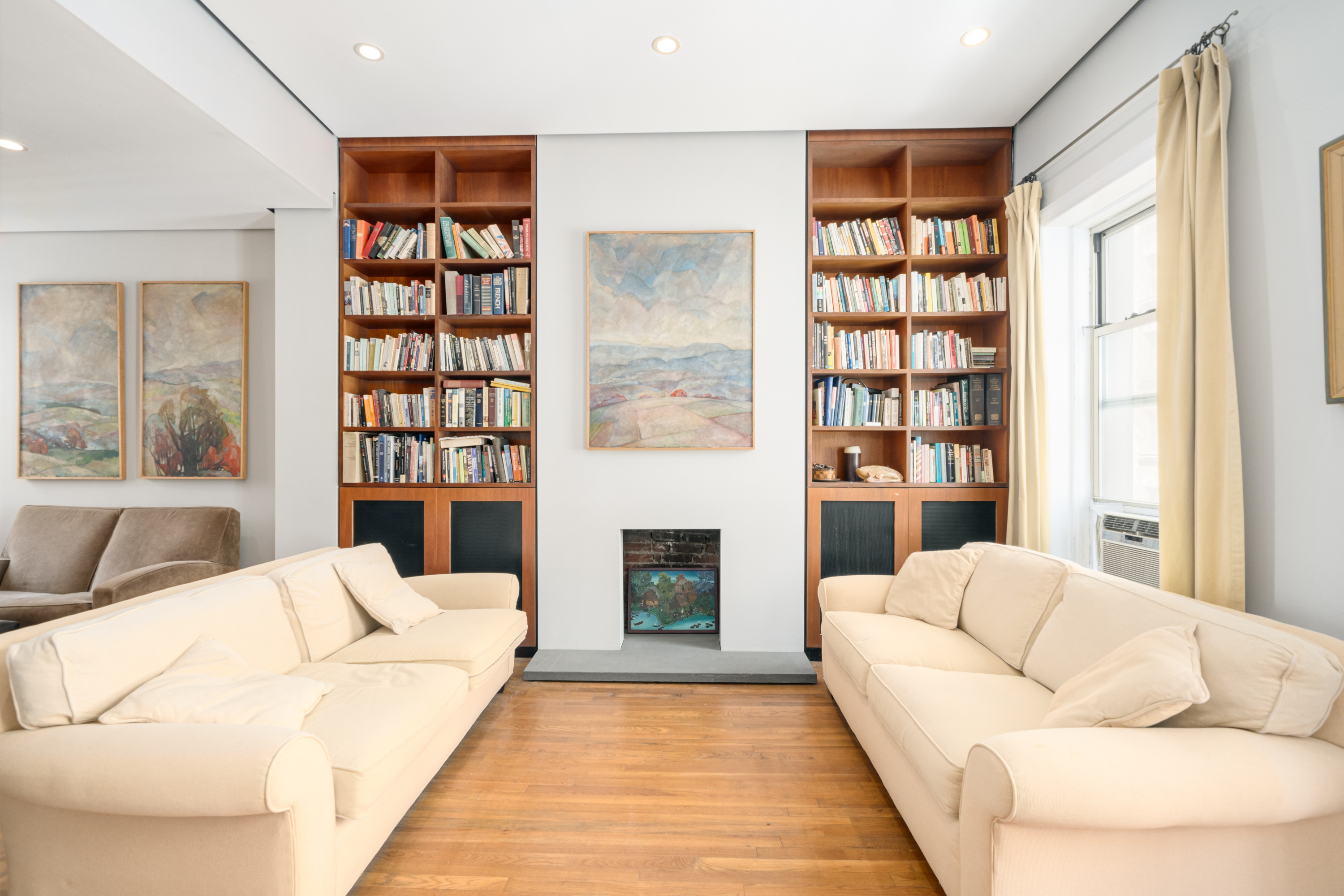 a living room with furniture fireplace and book shelf