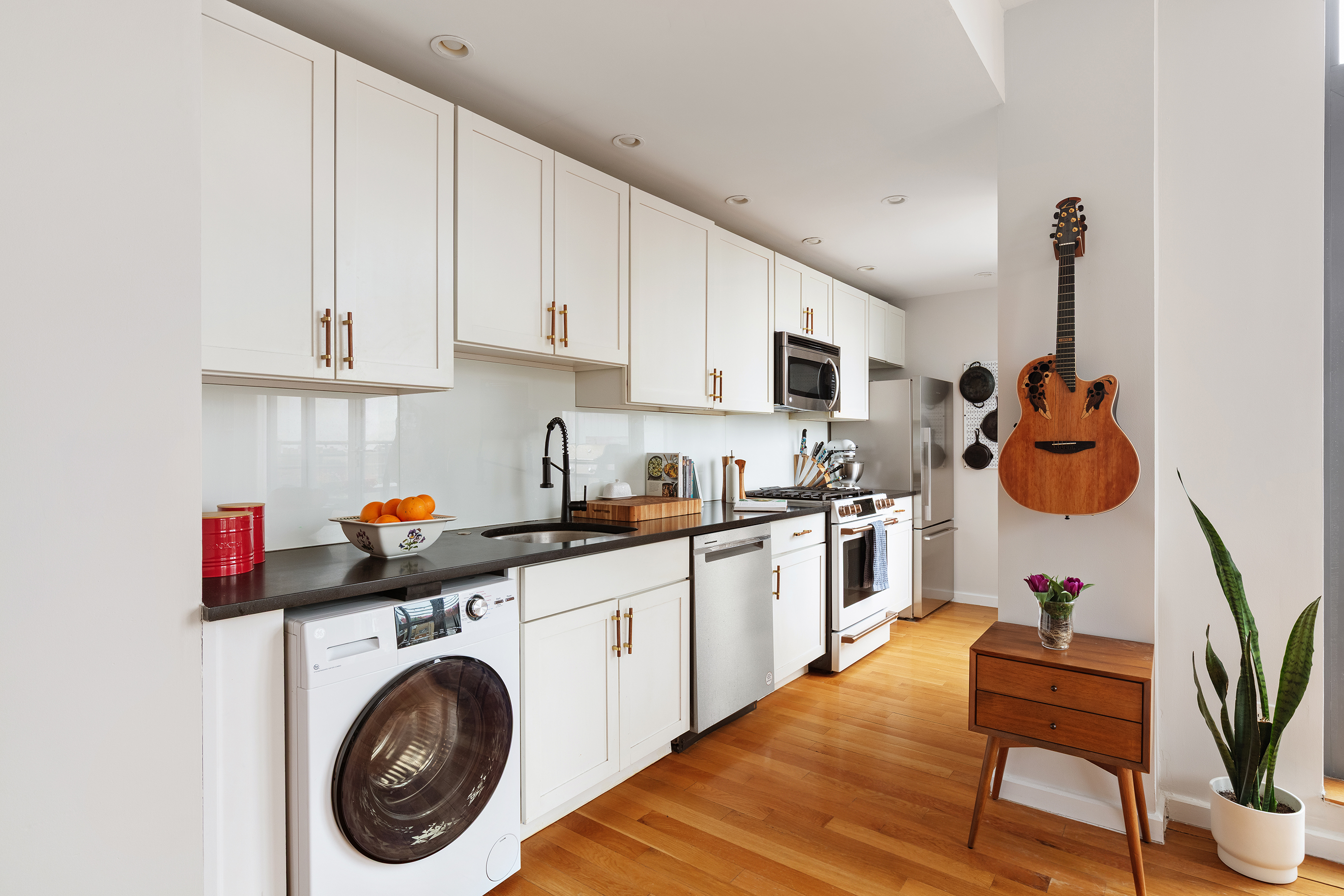 82 Irving Place, Unit 7C Brooklyn, NY 11238 - Photo 5 of 16 a kitchen with stainless steel appliances granite countertop a sink a stove top oven a counter space and cabinets