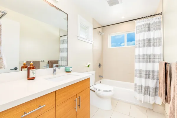 a bathroom with a sink a toilet and shower curtain