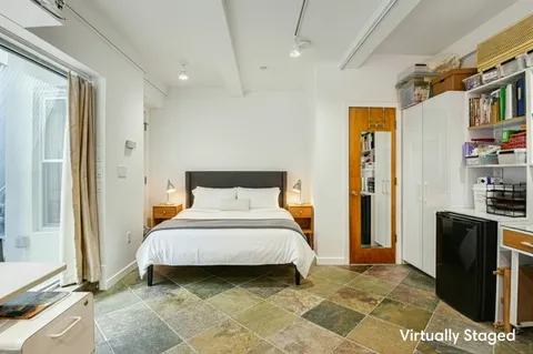 a bedroom with a bed and a television