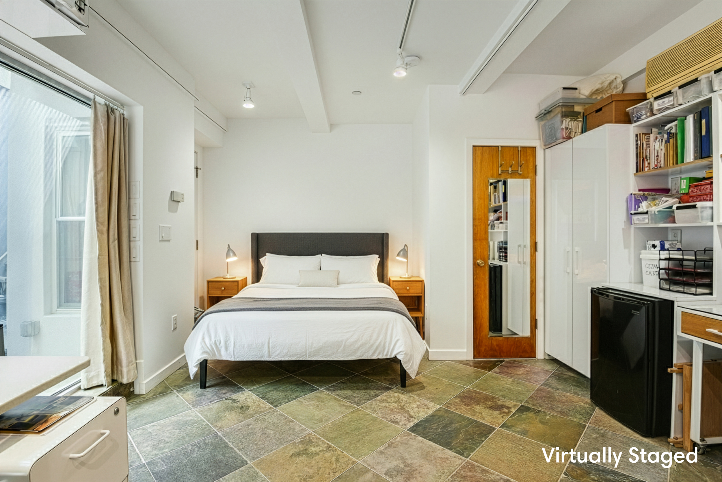 335 Warren Street, Unit 102 Brooklyn, NY 11201 - Photo 14 of 20 a bedroom with a bed and a television
