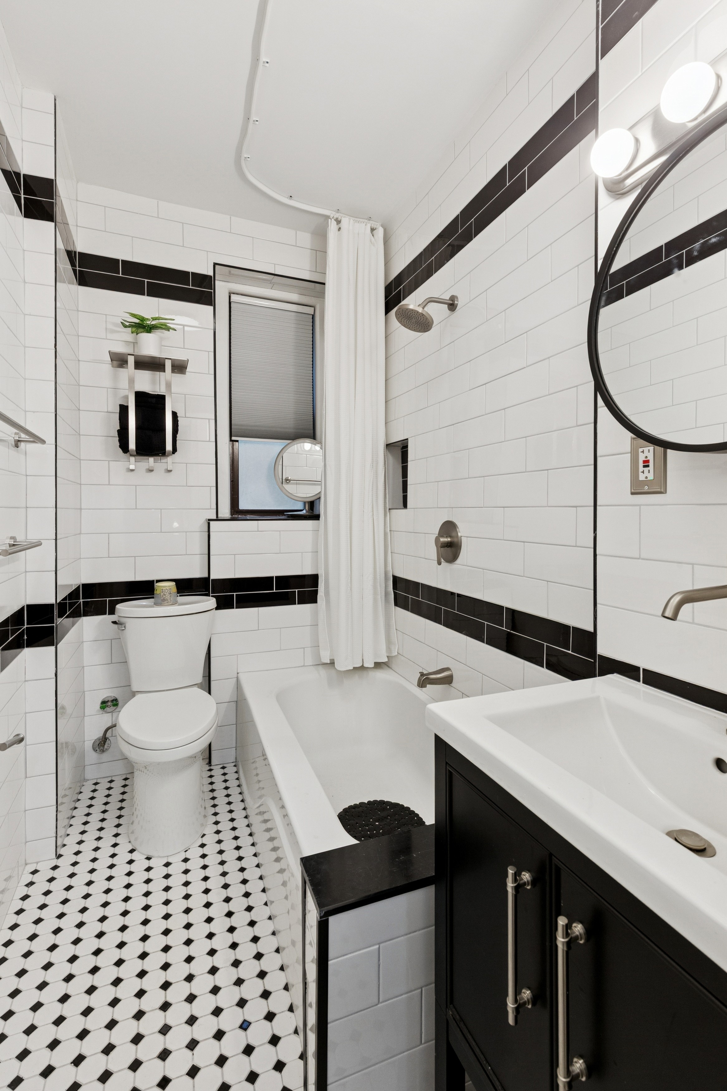 870 West 181st Street, Unit 2A Manhattan, NY 10033 - Photo 5 of 9 a bathroom with a sink a toilet and a mirror