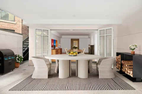 a front view of a house with a yard and fountain