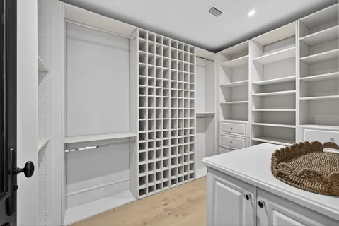 a kitchen with a sink a vanity and a glass door shower