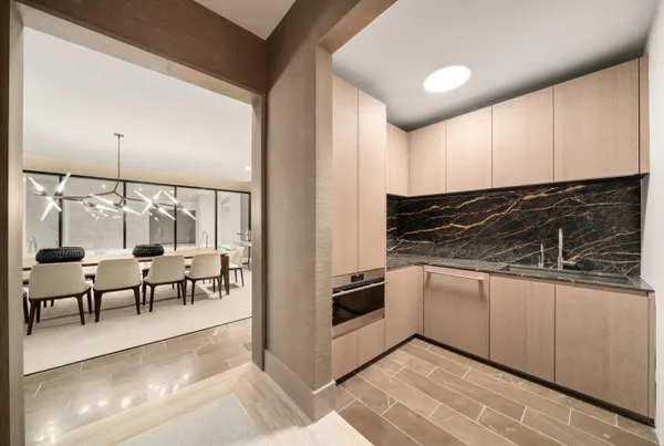 a kitchen with granite countertop a stove and white cabinets