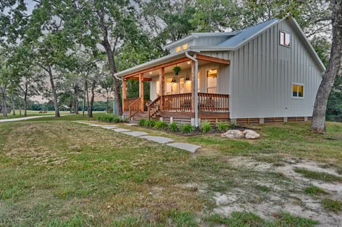 a living room with furniture appliances and a wooden floor