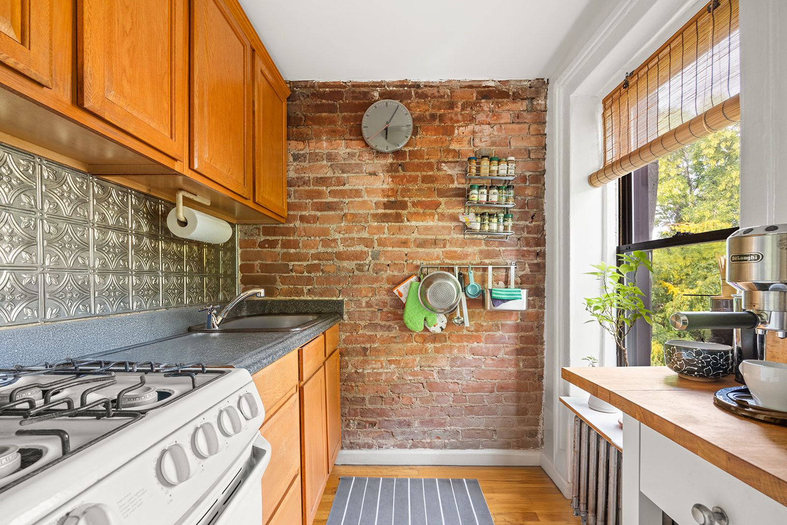 33 Park Place Brooklyn, NY 11217 - Photo 14 of 18 a kitchen with a stove a sink and a window