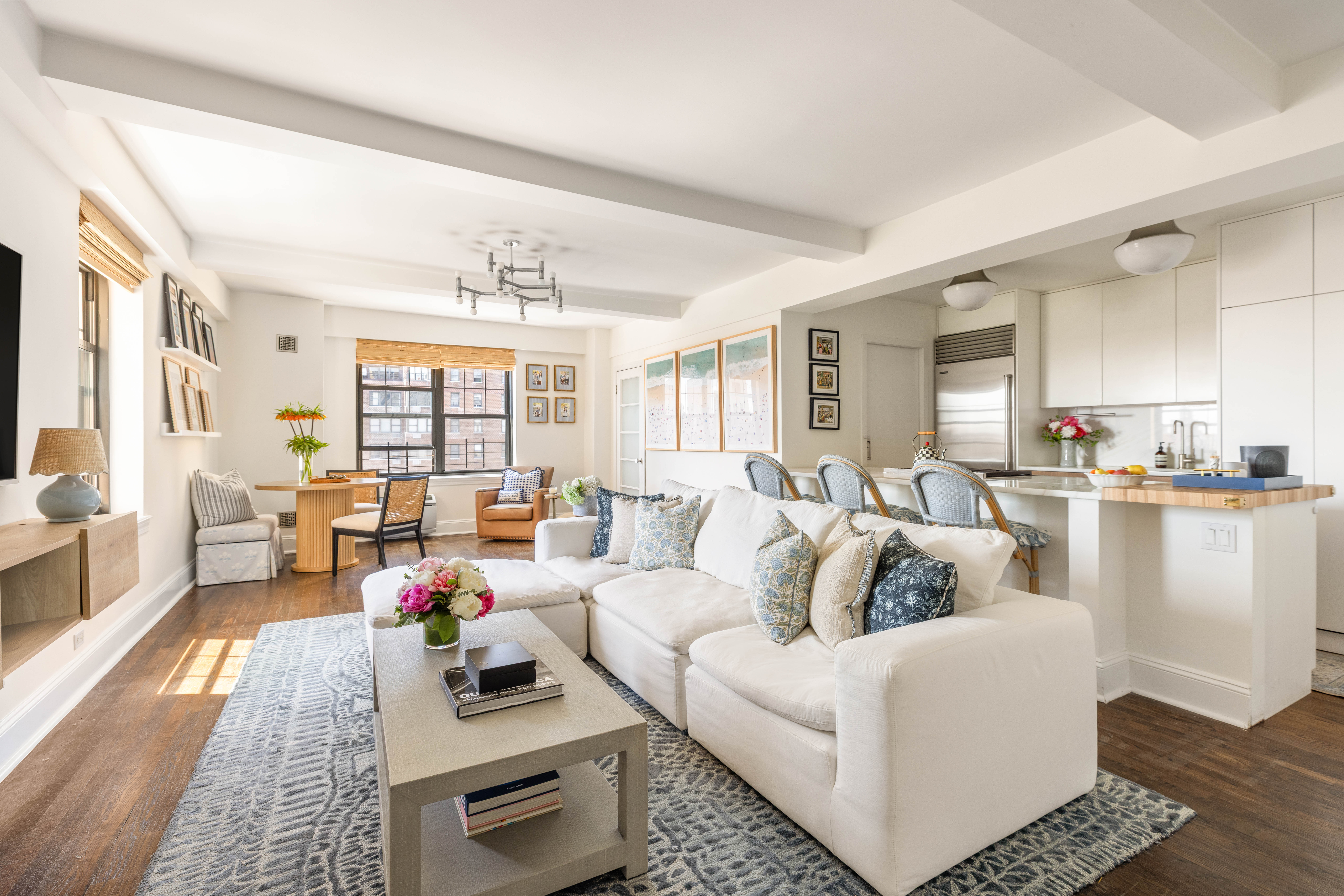 200 East 16th Street, Unit 14C Manhattan, NY 10003 - Photo 1 of 14 a living room with furniture and a large window
