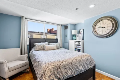 a bedroom with a bed and a couch