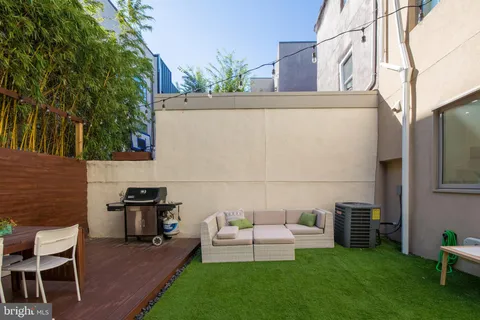 a view of a patio with couches chairs and a yard