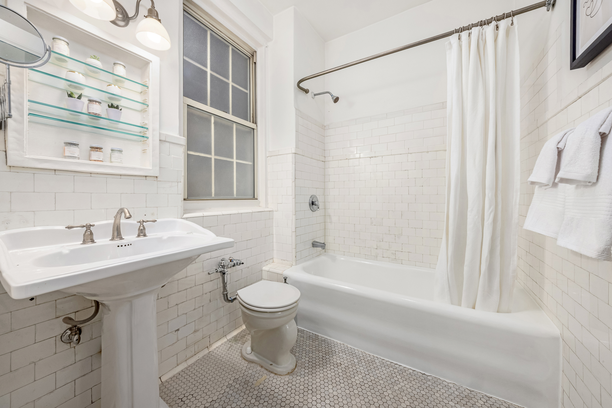 39 5th Avenue, Unit 2B Manhattan, NY 10003 - Photo 11 of 12 a bathroom with a sink toilet and shower