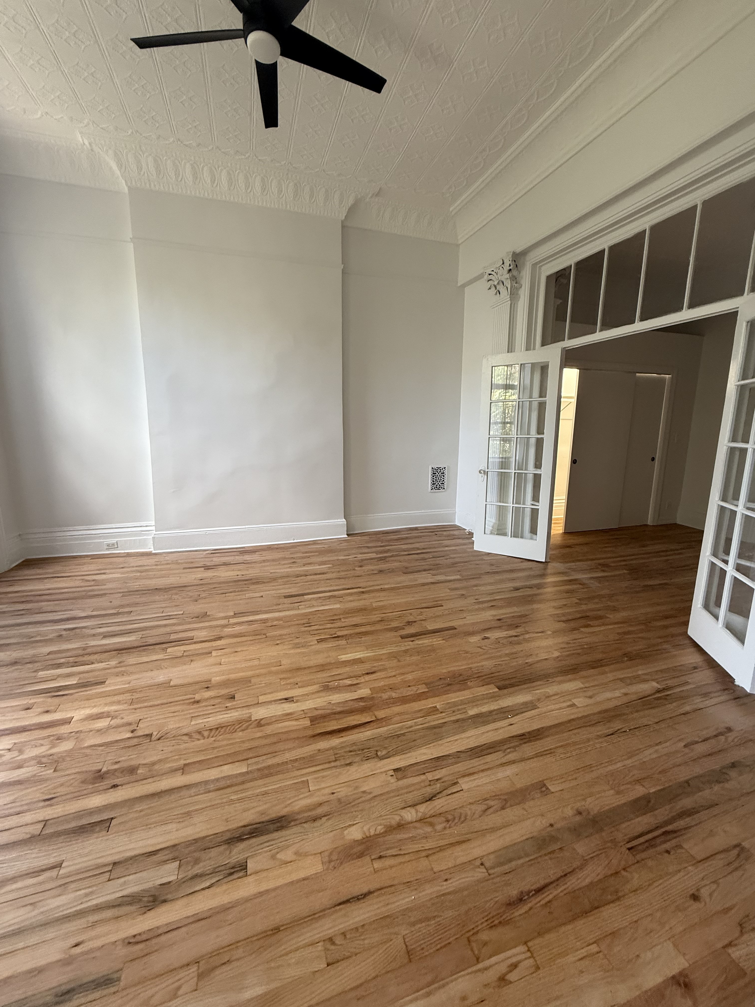 141 Summit Street, Unit 2 Brooklyn, NY 11231 - Photo 3 of 12 a view of an empty room with wooden floor and a window