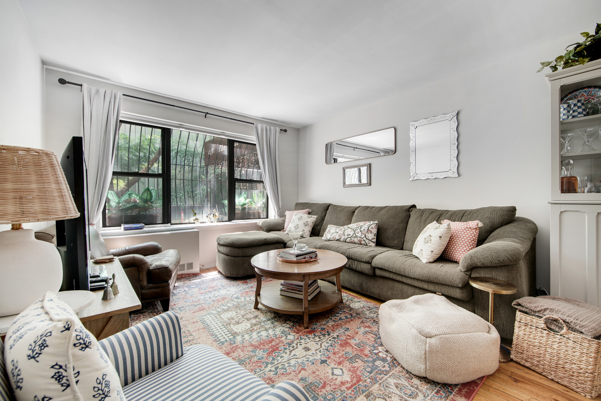 417 East 90th Street, Unit 1G Manhattan, NY 10128 - Photo 3 of 10 a living room with furniture and a large window