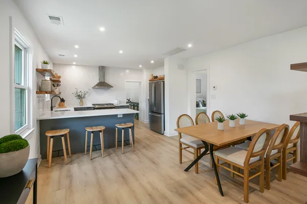 a dining room with furniture and wooden floor