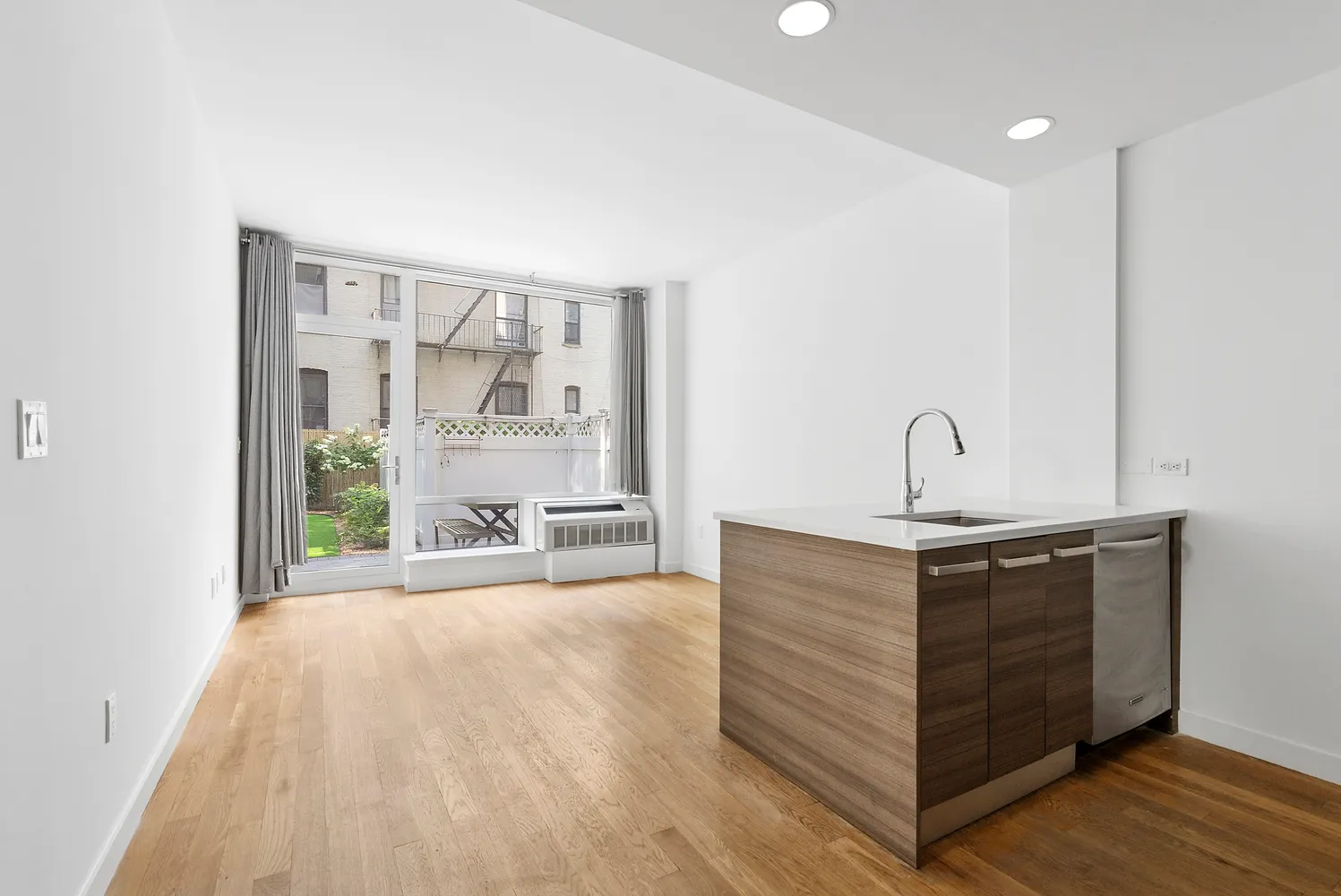 a view of a room with a sink and mirror