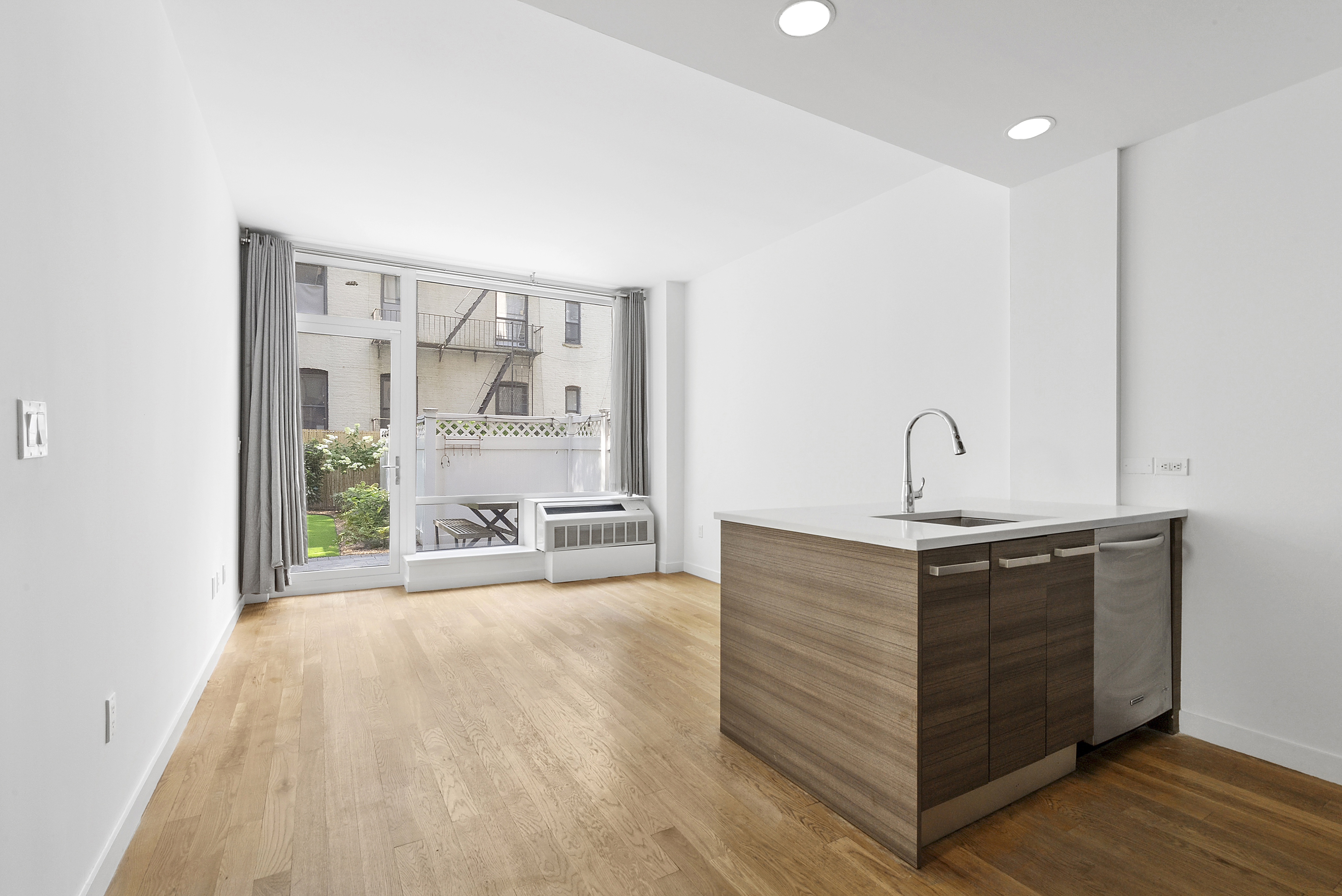 306 West 116th Street, Unit 1B Manhattan, NY 10026 - Photo 6 of 14 a view of a room with a sink and mirror