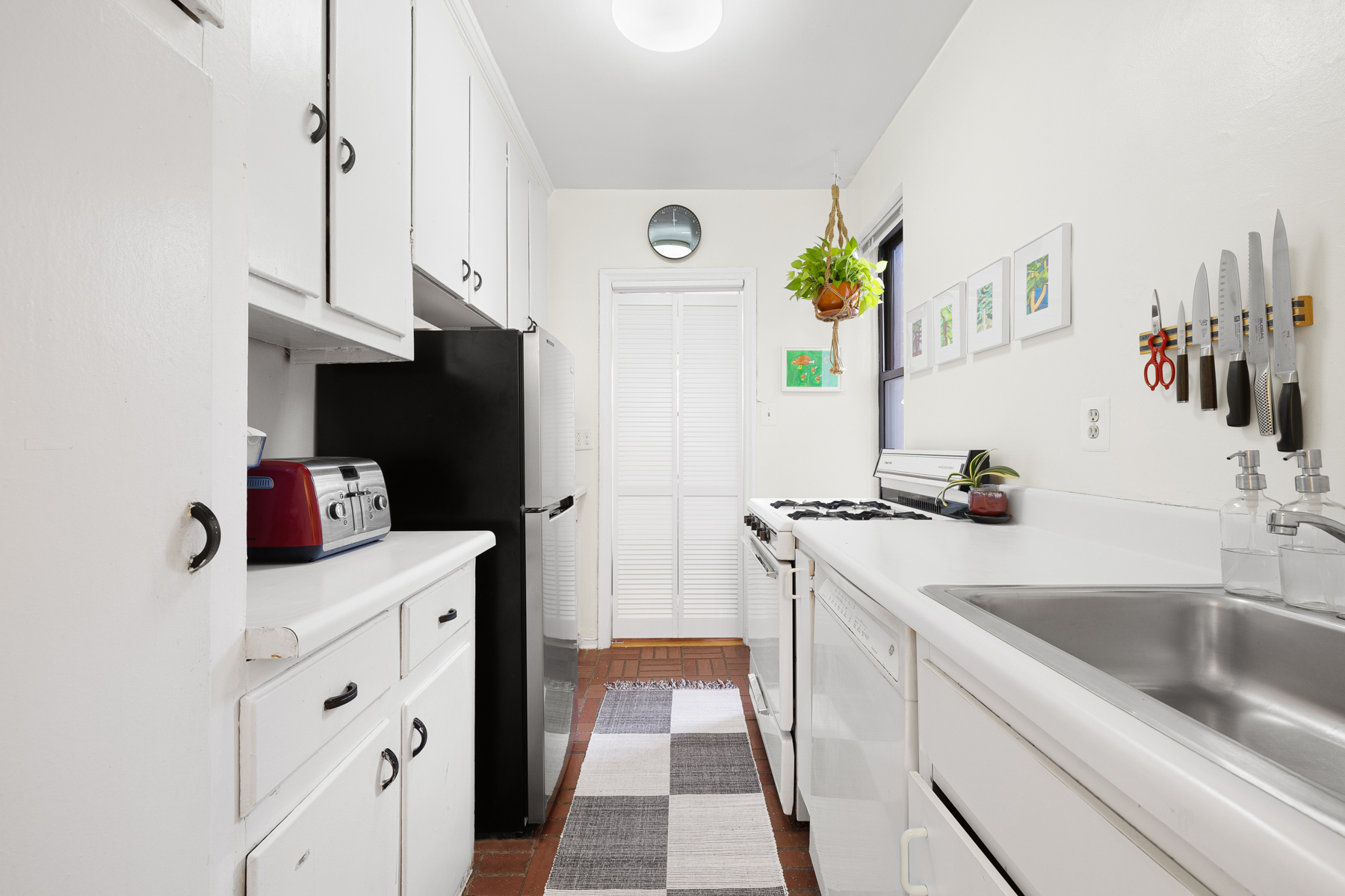 77-11 35th Avenue, Unit 3N Queens, NY 11372 - Photo 11 of 21 a kitchen with a sink and a refrigerator