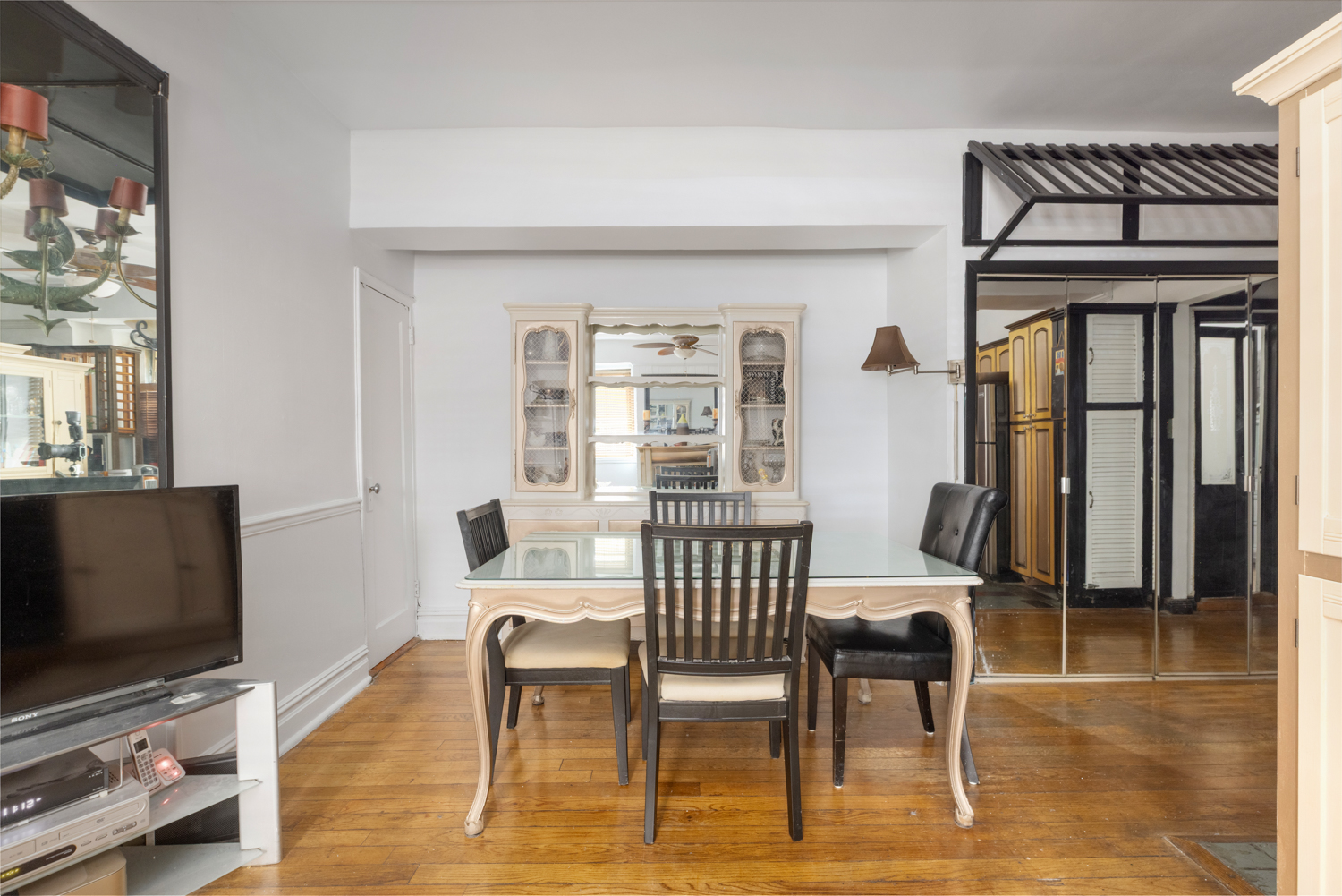 400 Riverside Drive, Unit K Manhattan, NY 10025 - Photo 14 of 22 a view of a dining room with furniture and a flat screen tv
