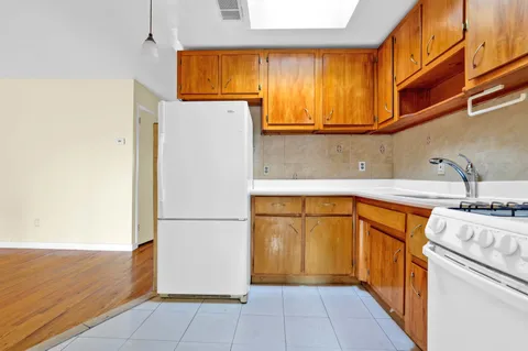 a kitchen with stainless steel appliances granite countertop a refrigerator and a sink