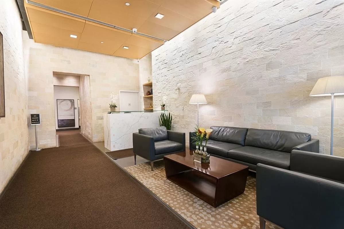 100 West 39th Street, Unit 37E Manhattan, NY 10018 - Photo 10 of 11 a living room with furniture and wooden floor