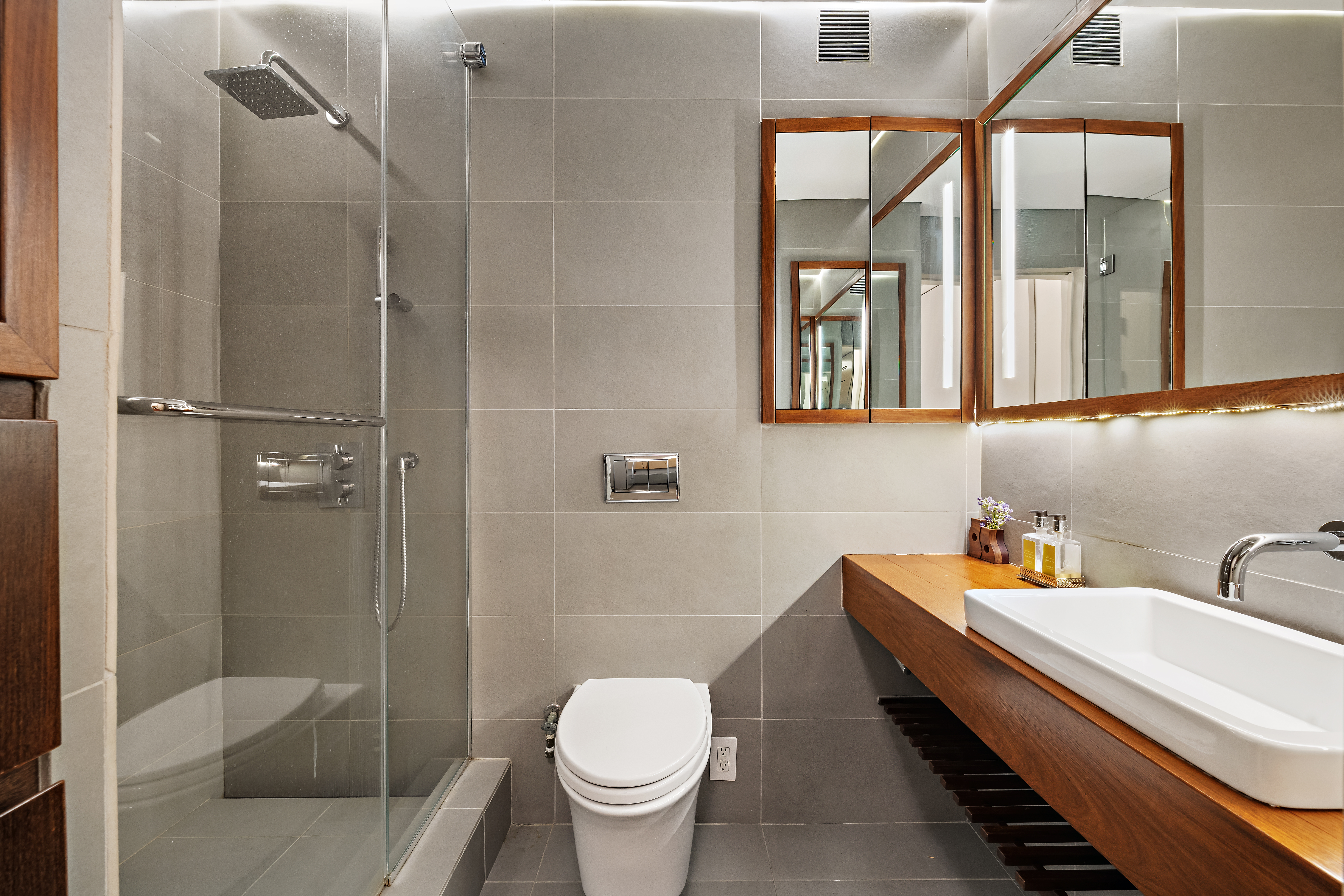 280 Rector Place, Unit 5IJ Manhattan, NY 10280 - Photo 9 of 10 a bathroom with a granite countertop bathtub sink vanity mirror and toilet