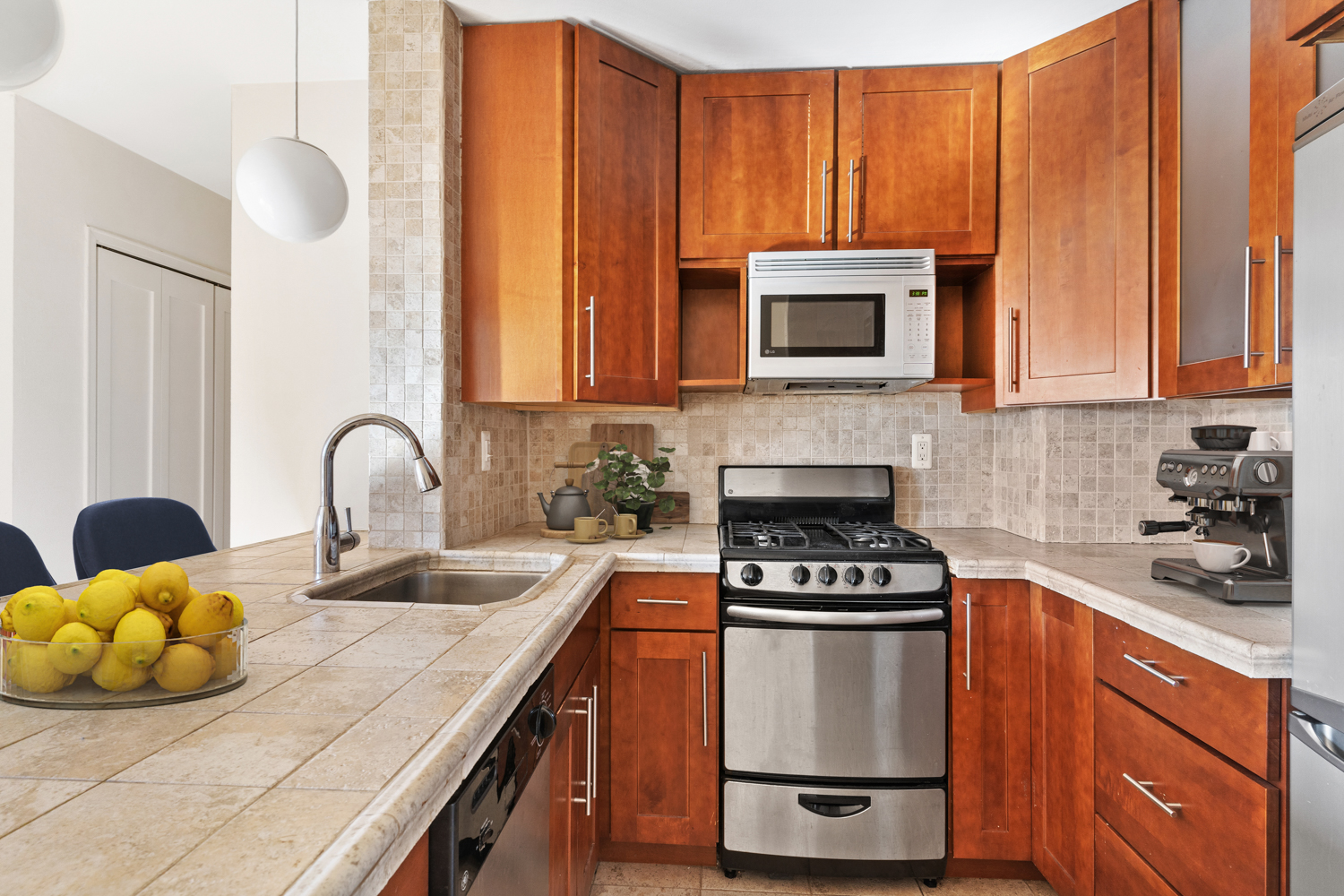 165 Christopher Street, Unit 5CC Manhattan, NY 10014 - Photo 3 of 13 a kitchen with a sink a stove and cabinets