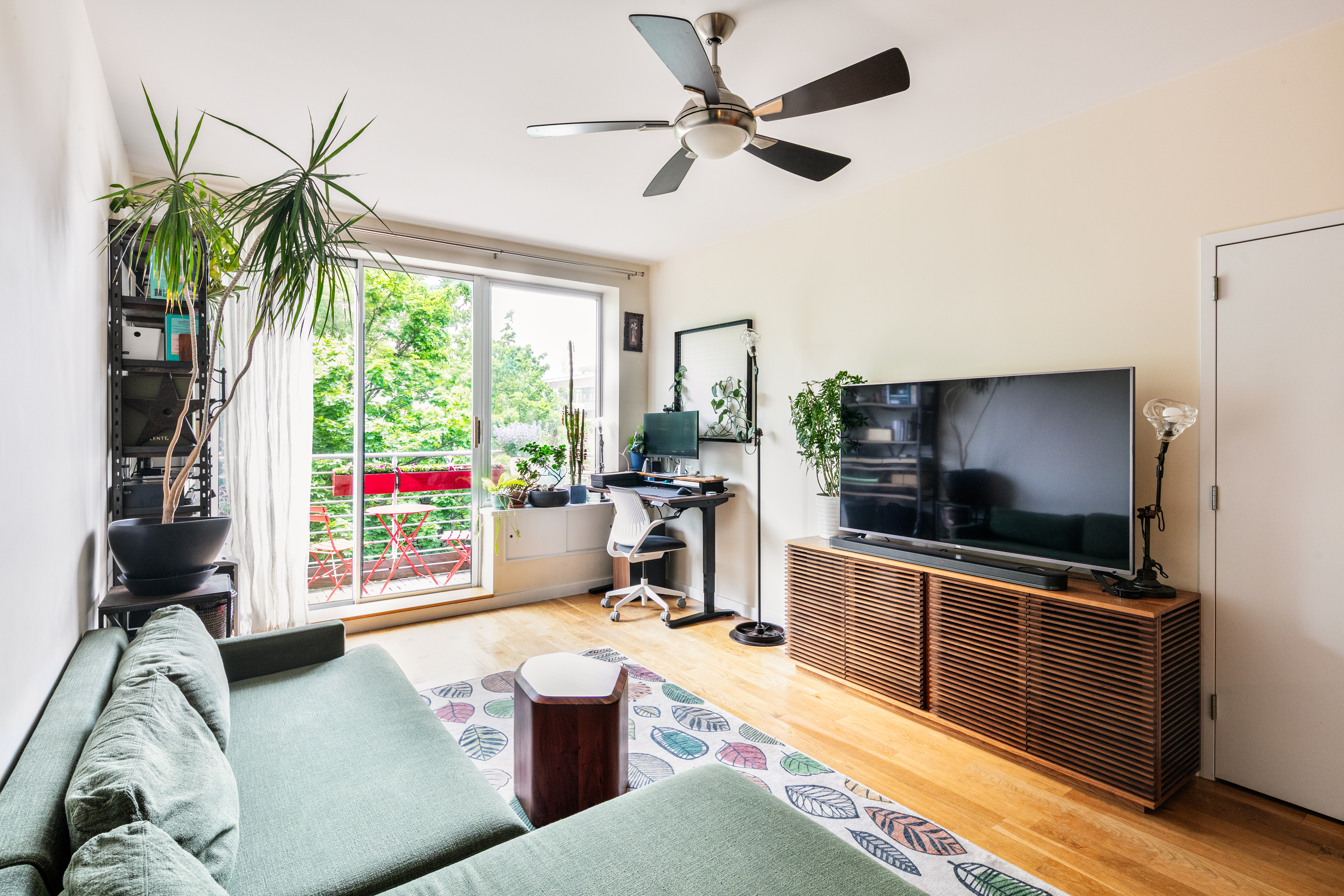 111 Monroe Street, Unit 4B Brooklyn, NY 11216 - Photo 1 of 8 a living room with furniture and a flat screen tv