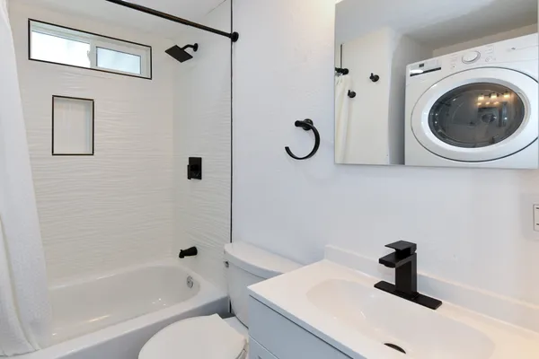 a bathroom with a sink a toilet and a bathtub