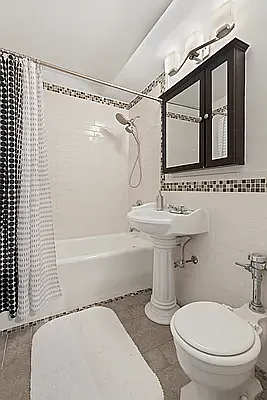 405 West 23rd Street, Unit 10D Manhattan, NY 10011 - Photo 4 of 9 a bathroom with a sink toilet and shower