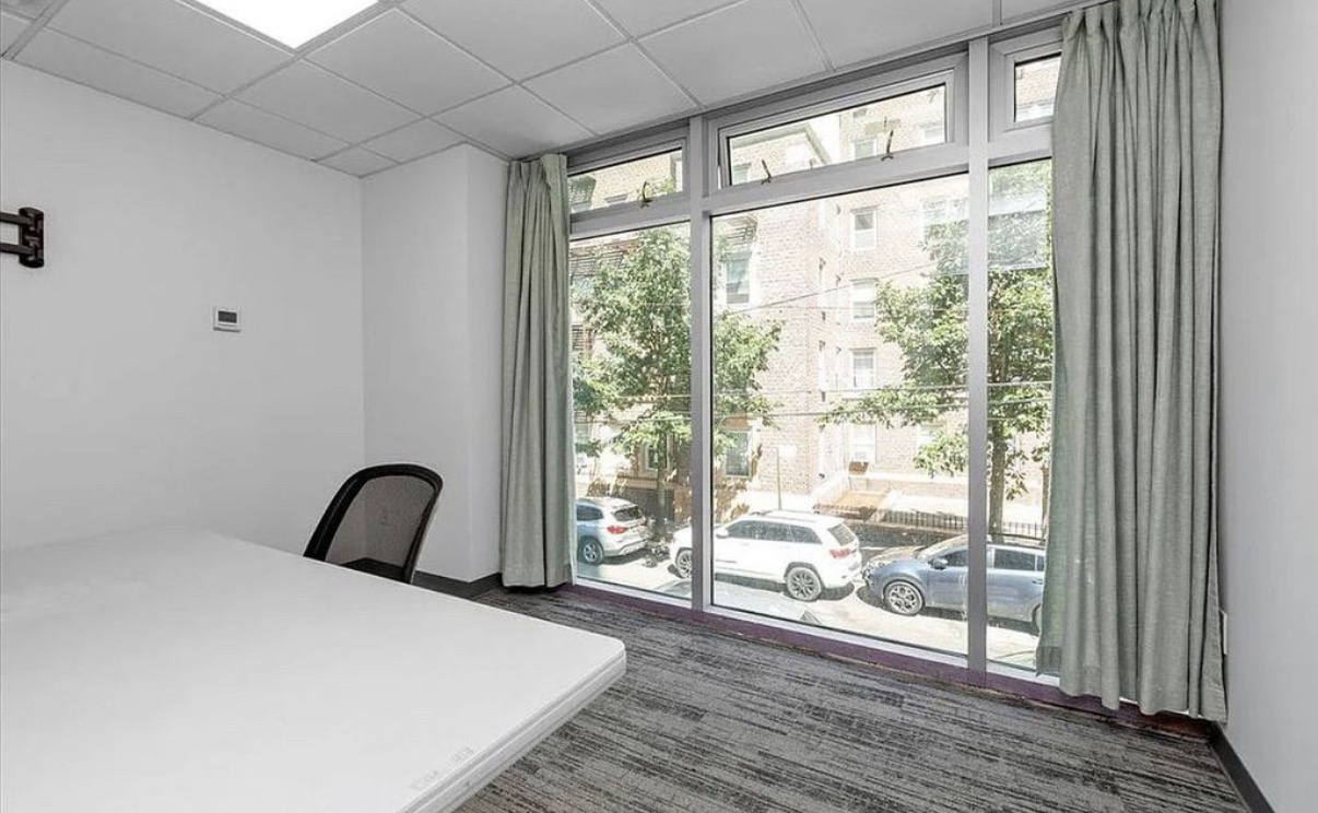 142-38 37th Avenue, Unit 2G Flushing, NY 11354 - Photo 4 of 8 a bedroom with a bed and a large window