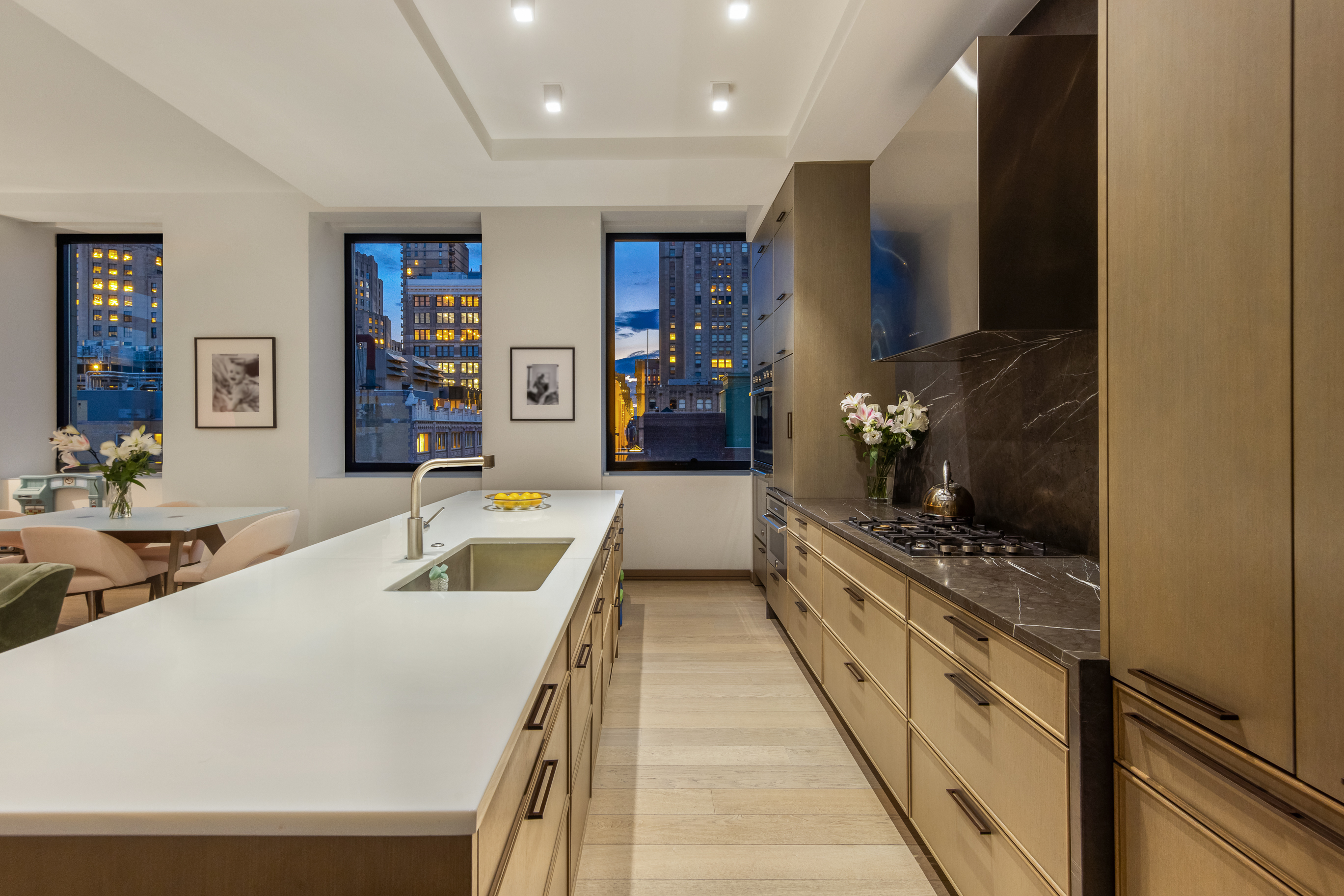 88 Lexington Avenue, Unit 1606 Manhattan, NY 10010 - Photo 3 of 20 a large white kitchen with kitchen island a stove a sink and a refrigerator
