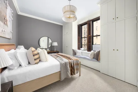 a bedroom with bed and a window