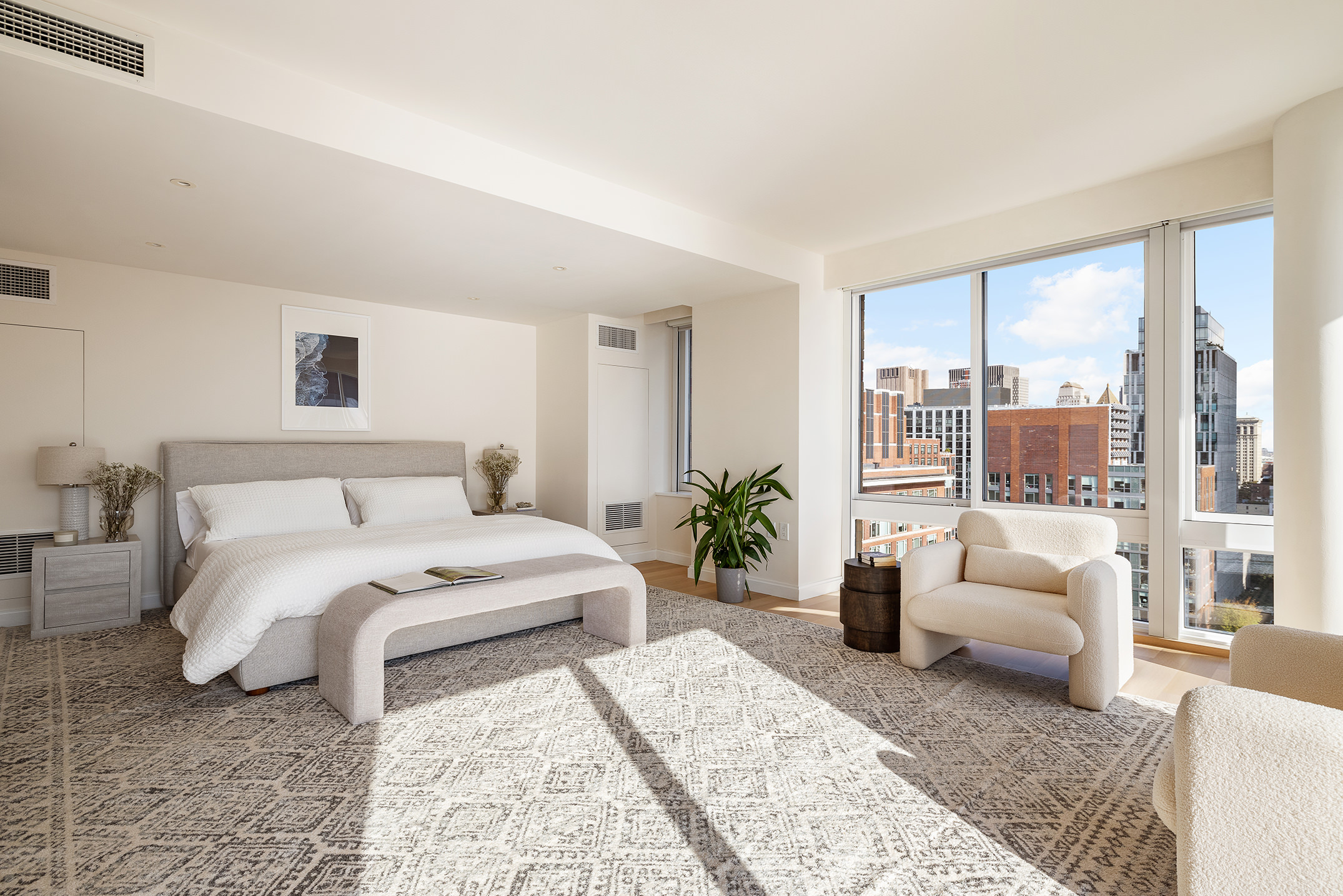 212 Warren Street, Unit PHS Manhattan, NY 10282 - Photo 9 of 18 a bedroom with a large bed and a couch