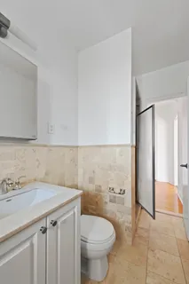 a bathroom with a sink a toilet and a shower