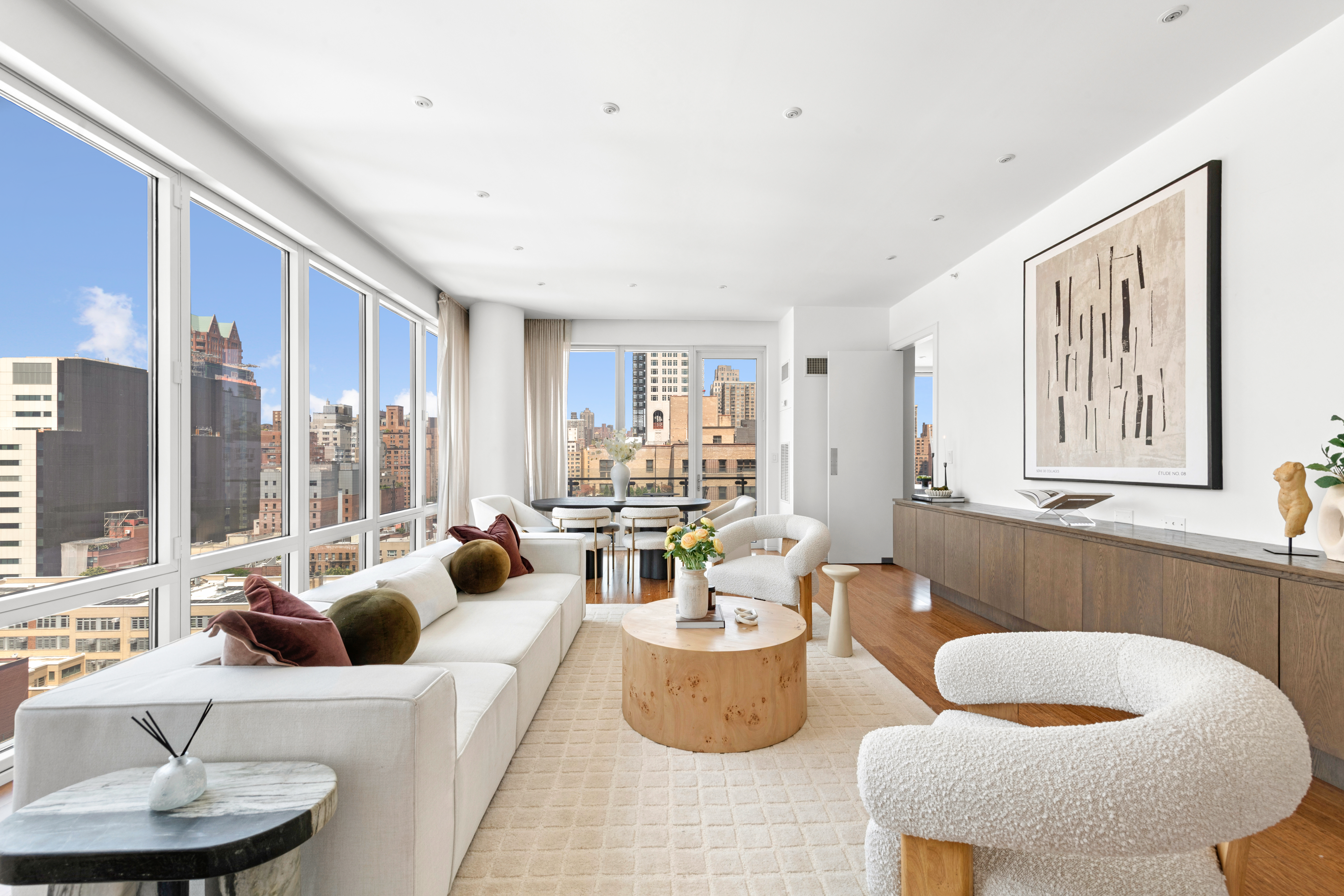 255 East 74th Street, Unit 14C Manhattan, NY 10021 - Photo 2 of 14 a living room with furniture and a large window