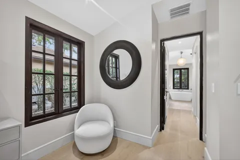 a bathroom with a toilet and a mirror