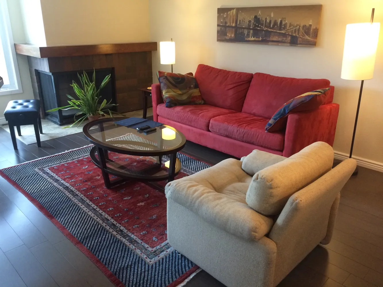 a living room with furniture a rug and a lamp