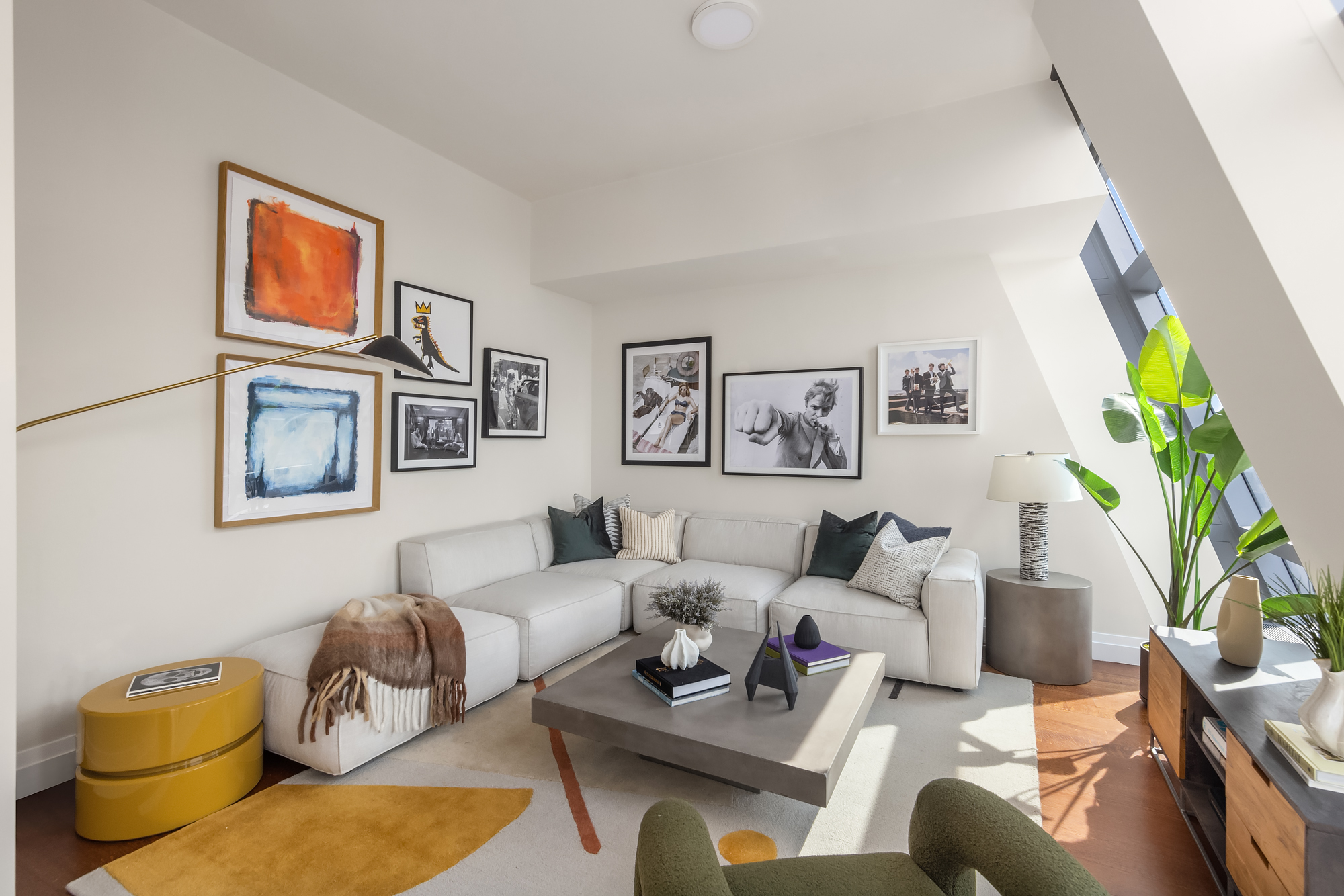 a living room with furniture potted plant and a window