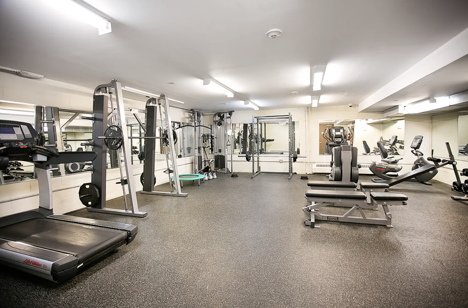 41-26 27th Street, Unit 4H Queens, NY 11101 - Photo 17 of 21 a room with gym equipment and mirrors