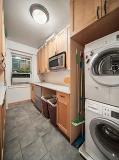a utility room with sink dryer and washer