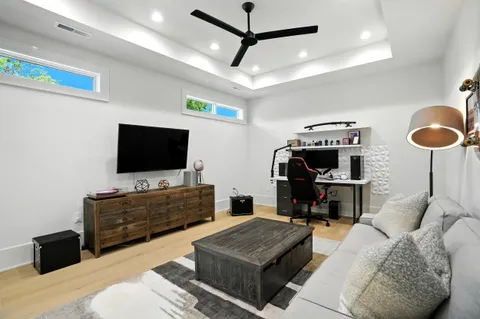 a living room with furniture and a wooden floor